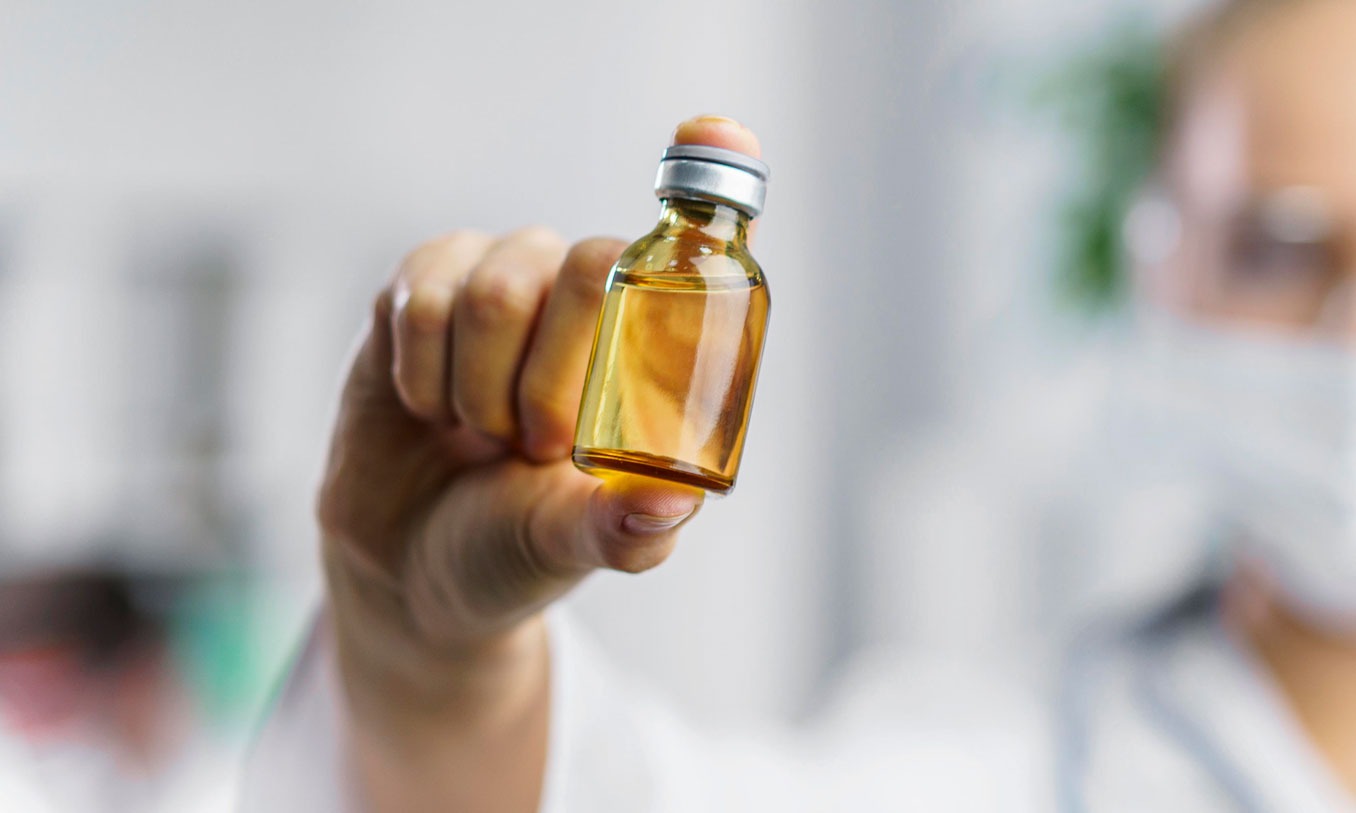 Farmaceutka prezentująca butelkę z olejem palmowym