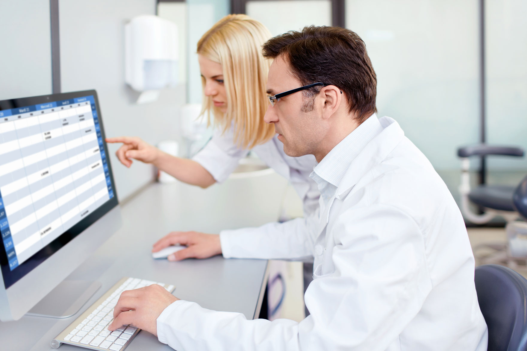 farmaceutka i farmaceuta patrza w monitor komputera